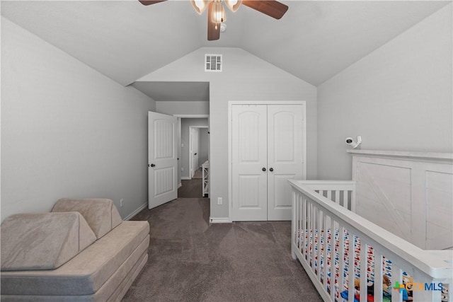 bedroom with dark colored carpet, a closet, a ceiling fan, visible vents, and lofted ceiling