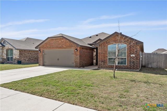 ranch-style home featuring brick siding, an attached garage, fence, and a front lawn