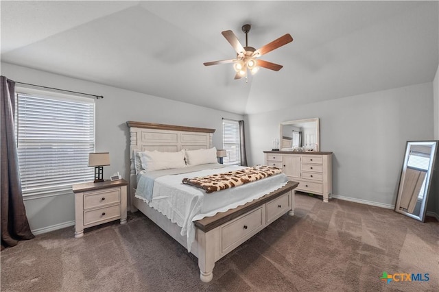 bedroom with baseboards, ceiling fan, dark colored carpet, and vaulted ceiling