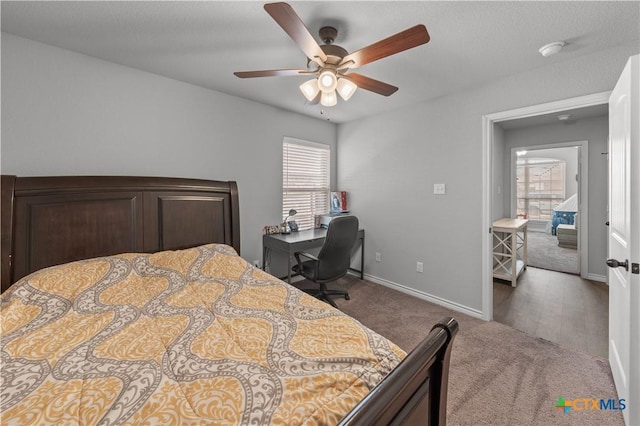 bedroom featuring carpet floors, baseboards, multiple windows, and a ceiling fan