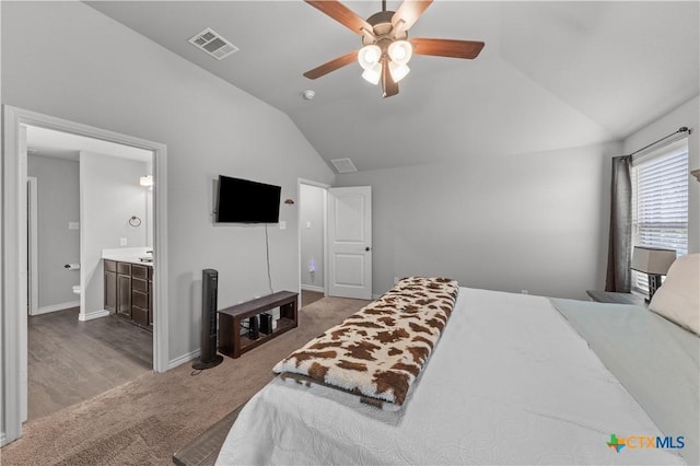 bedroom with visible vents, ceiling fan, carpet, ensuite bath, and vaulted ceiling