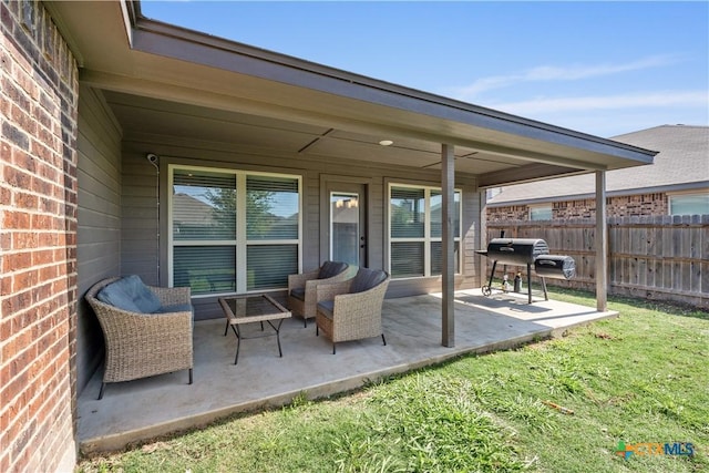 view of patio with an outdoor living space and fence
