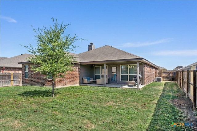 back of property with a patio area, a fenced backyard, and a lawn