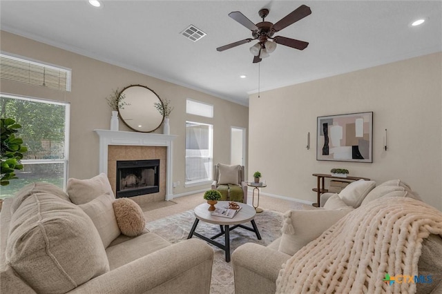 5708 High Meadow Dr, Temple, TX 76502 - carpeted living room featuring ceiling fan, a tiled fireplace, recessed lighting, and ornamental molding