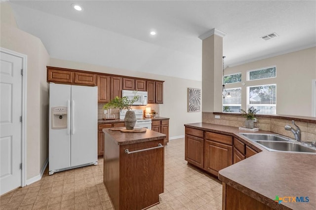 5708 High Meadow Dr, Temple, TX 76502 - kitchen with white appliances, decorative backsplash, a center island, dark countertops, and light floors