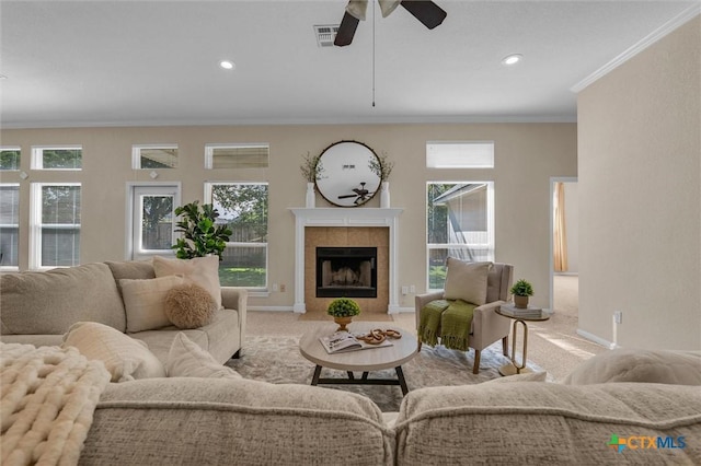 5708 High Meadow Dr, Temple, TX 76502 - carpeted living room featuring ornamental molding, ceiling fan, a tiled fireplace, and recessed lighting