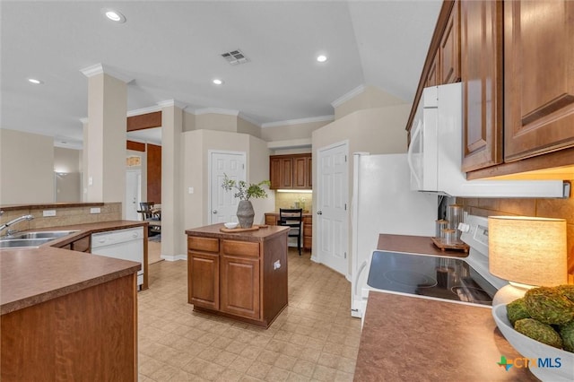 5708 High Meadow Dr, Temple, TX 76502 - kitchen featuring white appliances, ornamental molding, brown cabinetry, a center island, and backsplash