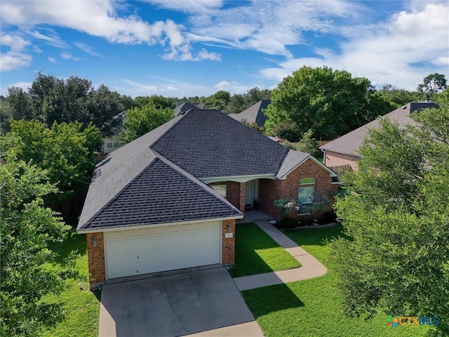 5708 High Meadow Dr, Temple, TX 76502 - view of front of house featuring brick siding, a shingled roof, a front lawn, concrete driveway, and a garage