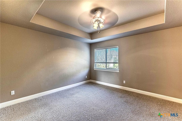 243 Arendes Dr, New Braunfels, TX 78132 - empty room with a tray ceiling, a ceiling fan, carpet flooring, and baseboards