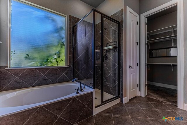 bathroom featuring plus walk in shower and tile patterned floors