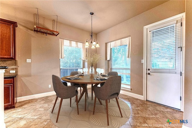 243 Arendes Dr, New Braunfels, TX 78132 - dining room featuring light tile patterned flooring, a chandelier, and baseboards