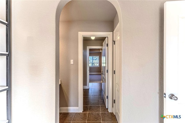 243 Arendes Dr, New Braunfels, TX 78132 - hall with dark tile patterned floors, baseboards, and arched walkways