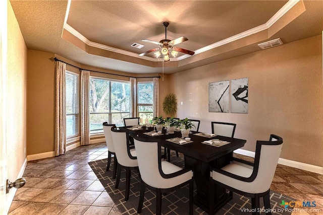 243 Arendes Dr, New Braunfels, TX 78132 - dining space with a tray ceiling, baseboards, a ceiling fan, and crown molding