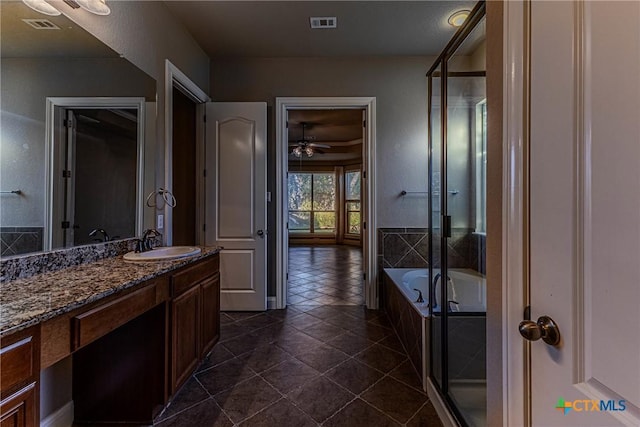 bathroom featuring plus walk in shower, vanity, tile patterned floors, and ceiling fan