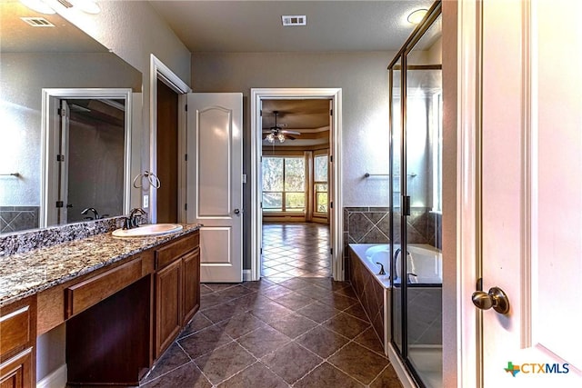 243 Arendes Dr, New Braunfels, TX 78132 - full bath featuring tile patterned floors, vanity, a shower with shower door, ceiling fan, and a bath