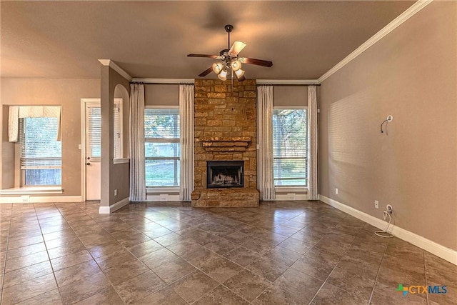 243 Arendes Dr, New Braunfels, TX 78132 - unfurnished living room featuring ceiling fan, baseboards, ornamental molding, and a fireplace