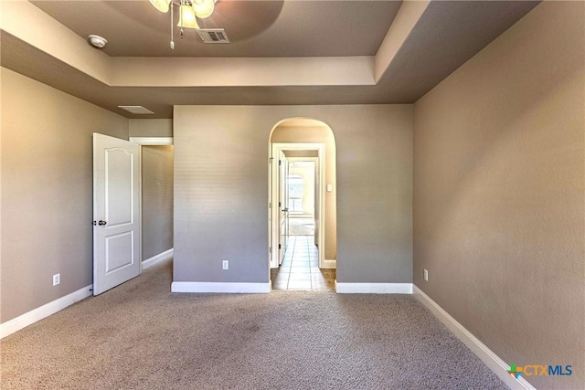 243 Arendes Dr, New Braunfels, TX 78132 - unfurnished bedroom with carpet flooring, a tray ceiling, and baseboards