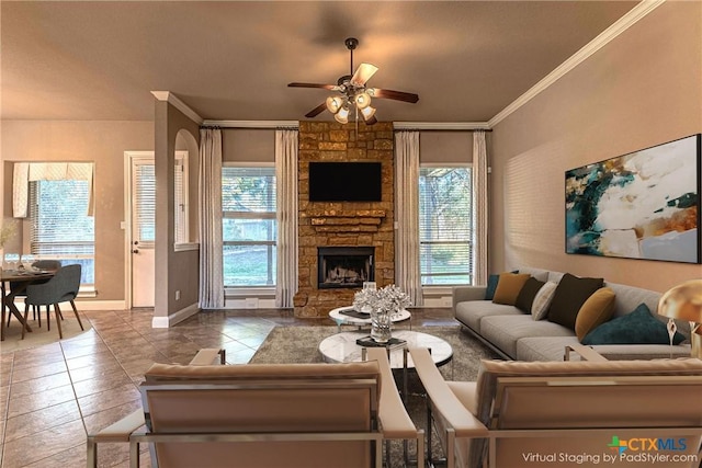 243 Arendes Dr, New Braunfels, TX 78132 - tiled living room with ceiling fan, ornamental molding, baseboards, and a fireplace