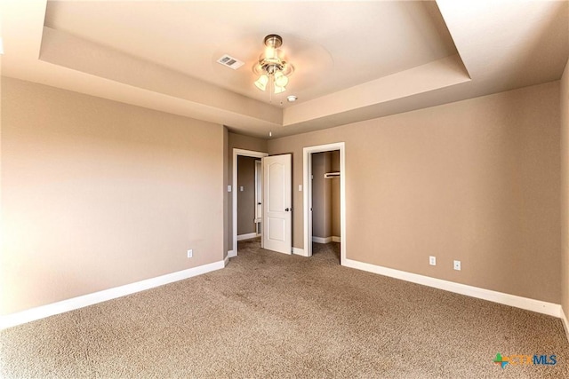 243 Arendes Dr, New Braunfels, TX 78132 - unfurnished bedroom featuring a raised ceiling, carpet floors, baseboards, a ceiling fan, and a closet