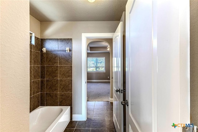 243 Arendes Dr, New Braunfels, TX 78132 - bathroom with tile patterned flooring, a textured ceiling, bathtub / shower combination, and baseboards