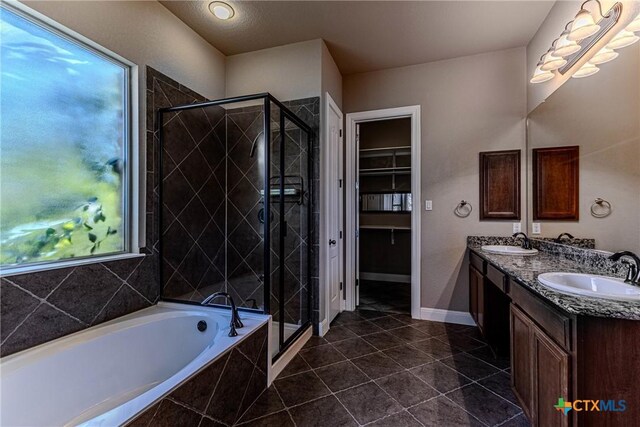 bathroom featuring a wealth of natural light, tile patterned flooring, vanity, and shower with separate bathtub