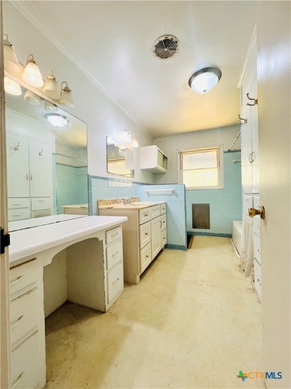 bathroom with tile walls, a tub, and crown molding