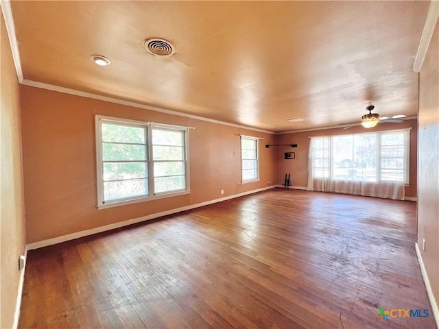 empty room with hardwood / wood-style floors, ceiling fan, and crown molding