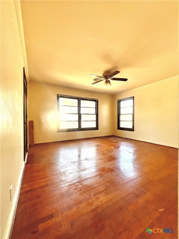 empty room featuring hardwood / wood-style flooring and ceiling fan