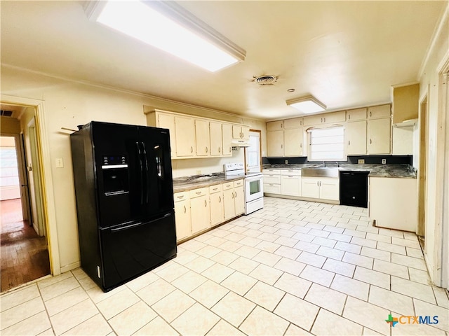 kitchen featuring light wood-type flooring, sink, black appliances, and cream cabinets