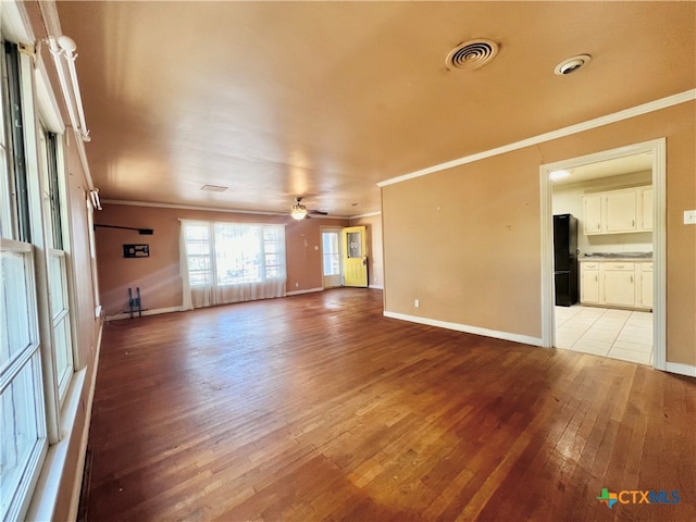 unfurnished living room with ornamental molding, light hardwood / wood-style flooring, and ceiling fan