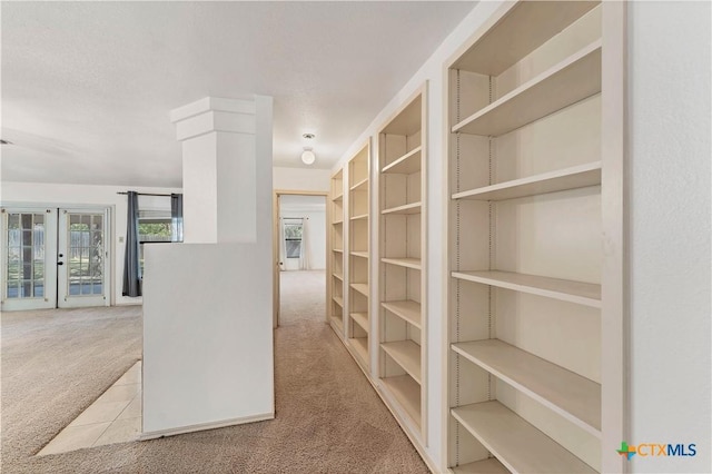 walk in closet with carpet flooring and french doors