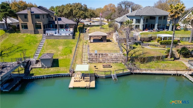 birds eye view of property with a water view and a residential view