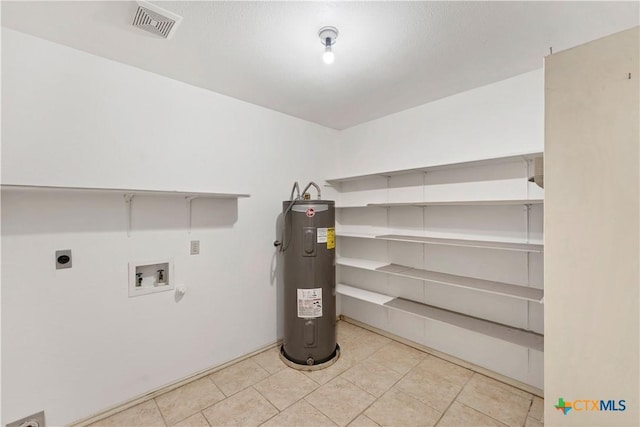 clothes washing area with visible vents, electric water heater, laundry area, hookup for a washing machine, and hookup for an electric dryer