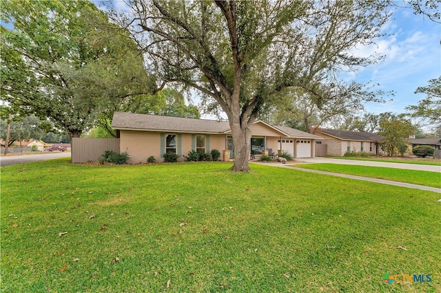 ranch-style home with a garage and a front yard