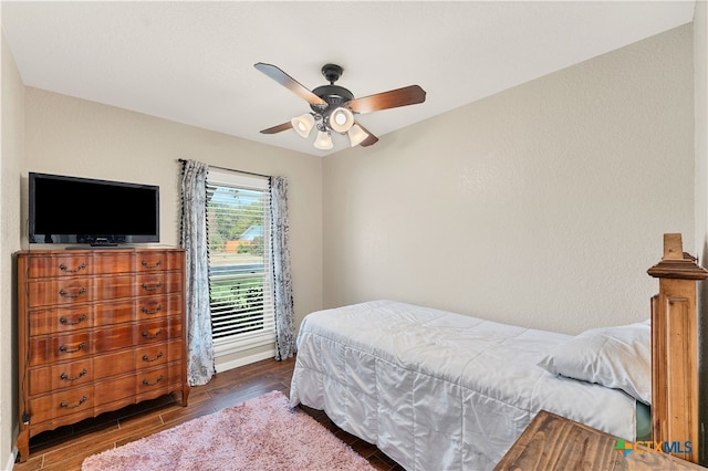 bedroom with ceiling fan and dark hardwood / wood-style floors