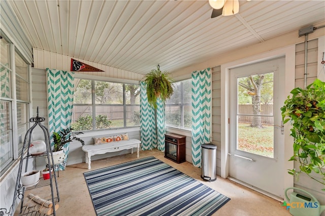 sunroom / solarium featuring ceiling fan and vaulted ceiling