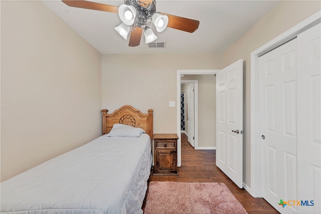 bedroom featuring ceiling fan, a closet, and dark hardwood / wood-style flooring