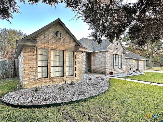 view of front of house featuring a front lawn and a garage