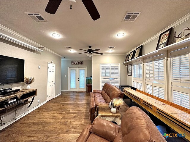 living room with wood-type flooring, french doors, crown molding, a textured ceiling, and ceiling fan