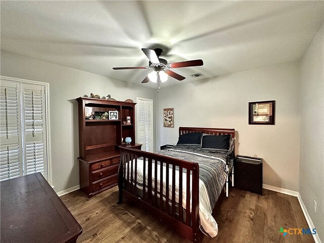 bedroom featuring dark hardwood / wood-style flooring and ceiling fan