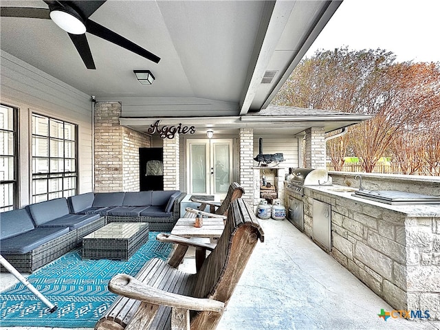 view of patio / terrace featuring exterior kitchen, ceiling fan, area for grilling, and an outdoor hangout area