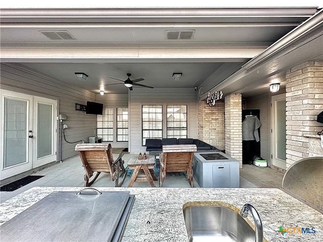 view of patio featuring french doors, ceiling fan, and sink