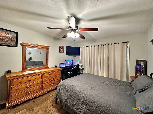 bedroom with hardwood / wood-style flooring and ceiling fan