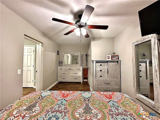 bedroom with dark hardwood / wood-style flooring and ceiling fan