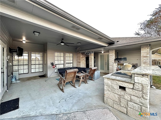 view of patio featuring ceiling fan and exterior kitchen