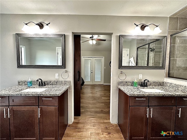 bathroom with vanity, wood-type flooring, ceiling fan, and a shower with shower door