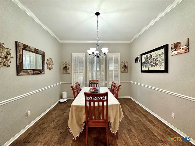 dining area with ornamental molding, dark wood-type flooring, and an inviting chandelier