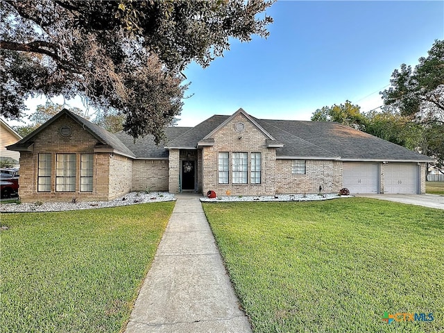 view of front facade with a front yard and a garage