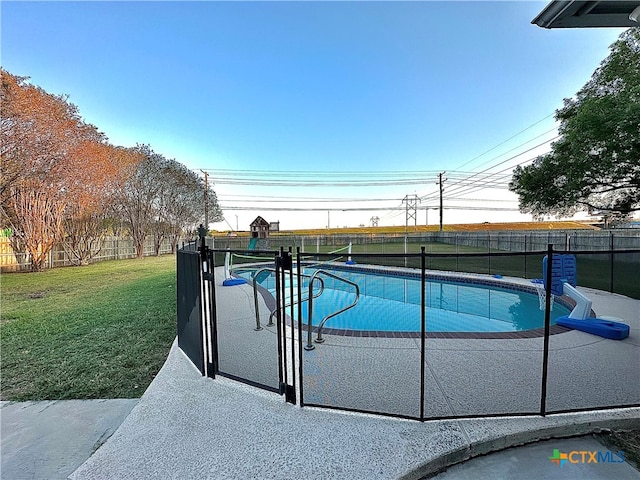 view of pool with a lawn