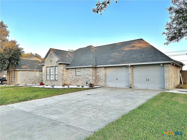 view of front facade with a garage and a front lawn